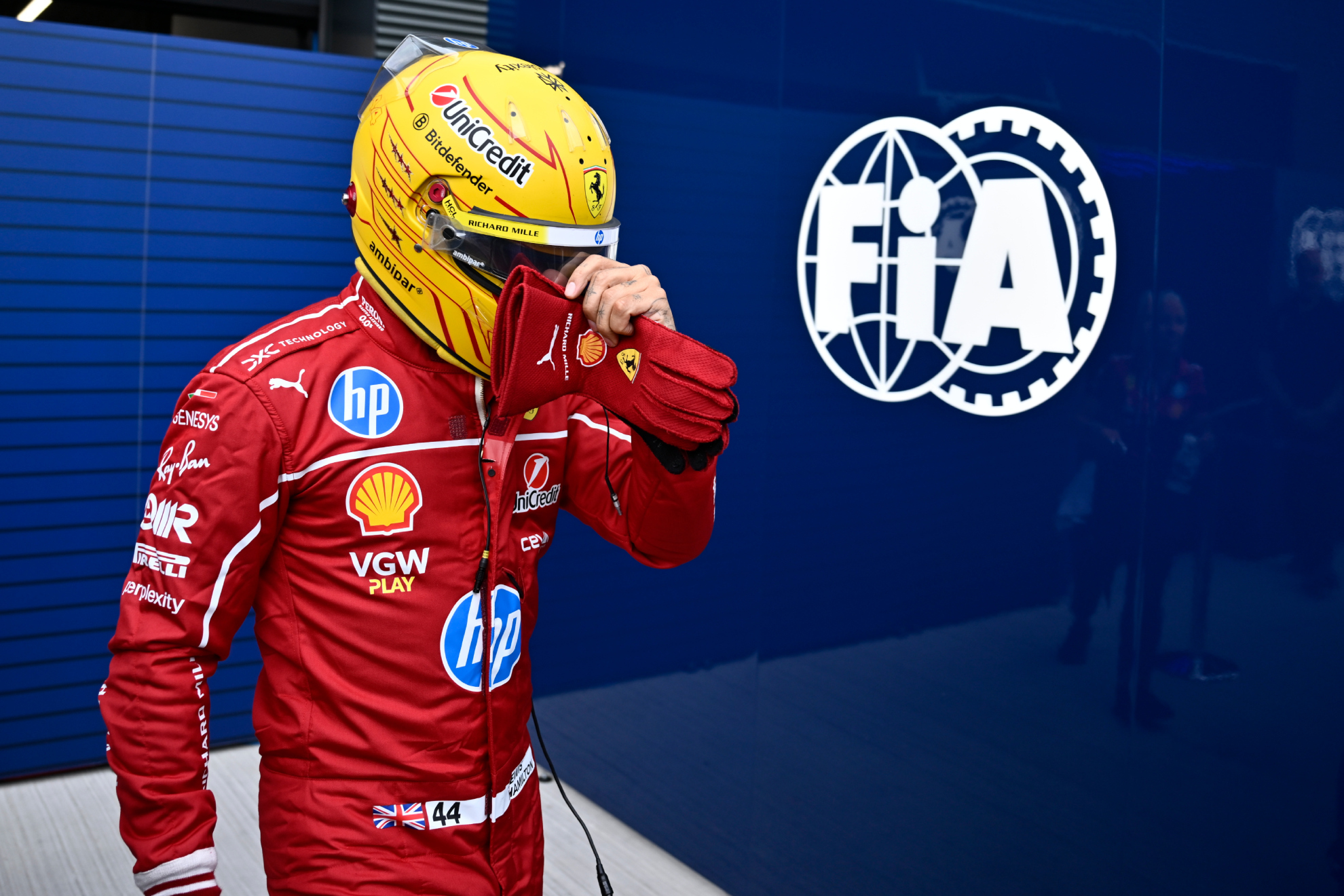 Ferrari driver Lewis Hamilton of Britain walks back to his pits after failing to complete during the qualifying session for the Hungarian Formula One Grand Prix at the Hungaroring racetrack in Mogyorod, Hungary, Saturday, Aug. 2, 2025.