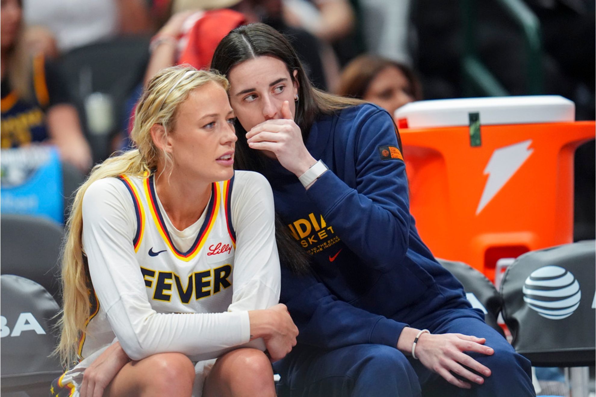 Indiana Fever guard Caitlin Clark, right, talks with guard Sophie Cunningham during the first half of a WNBA basketball game
